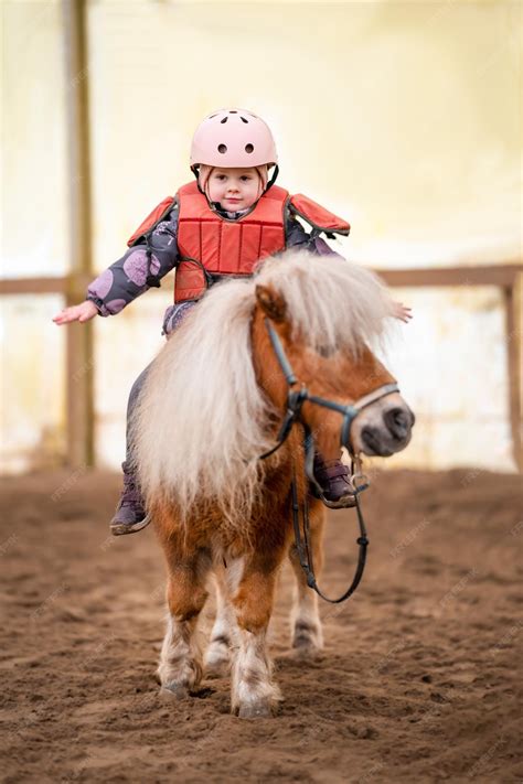 Des enfants heureux caressant un poney